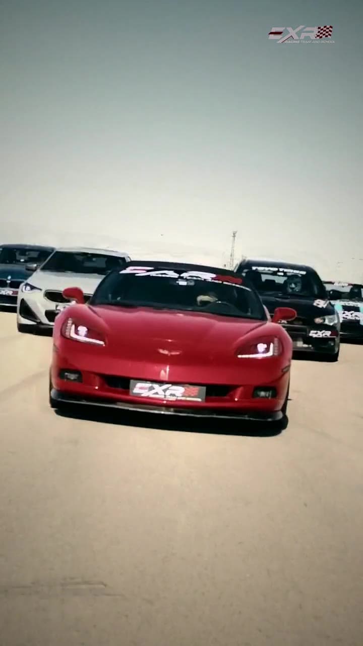 EXR's cars lined up on the Arad race track, the red Corvette in front
